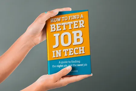 Hands holding a copy of the book “How to Find a Better Job in Tech.”